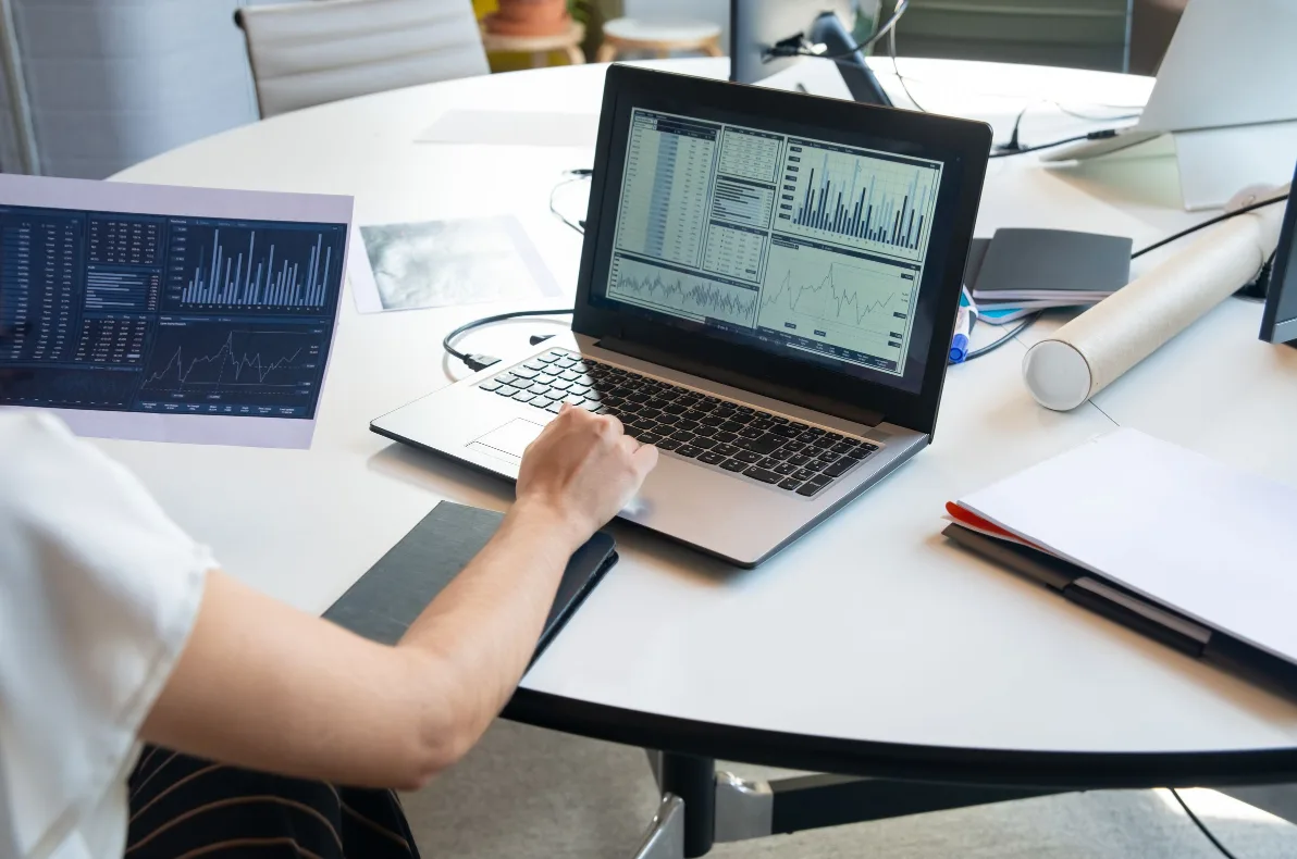 Reviewing Google Ads campaign performance charts on a laptop