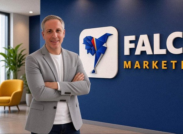 Trey Linder beside the Falco Marketing sign